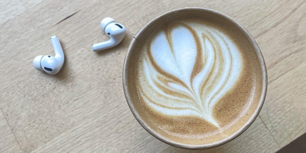 image of coffee cup with latte art and airpods